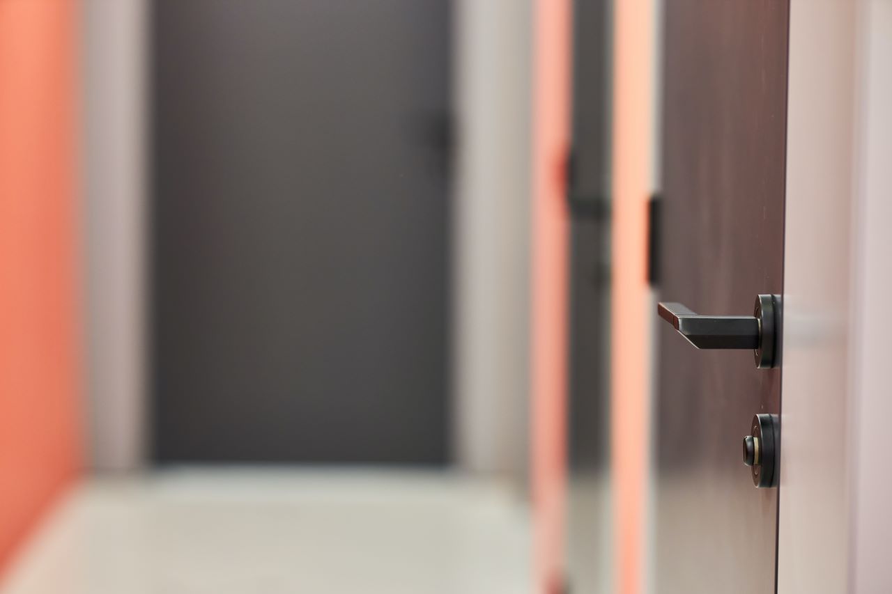 a closed wooden door in a blurred hallway